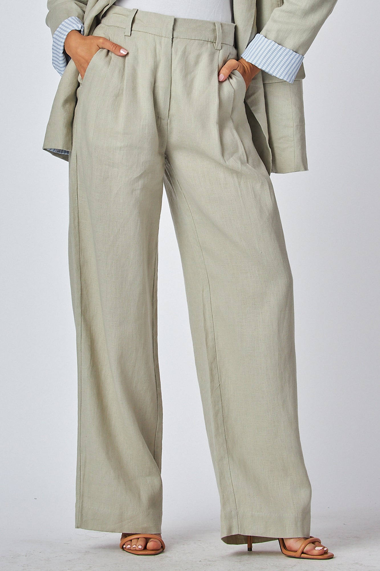 Model wearing a beige suit with wide-leg pants