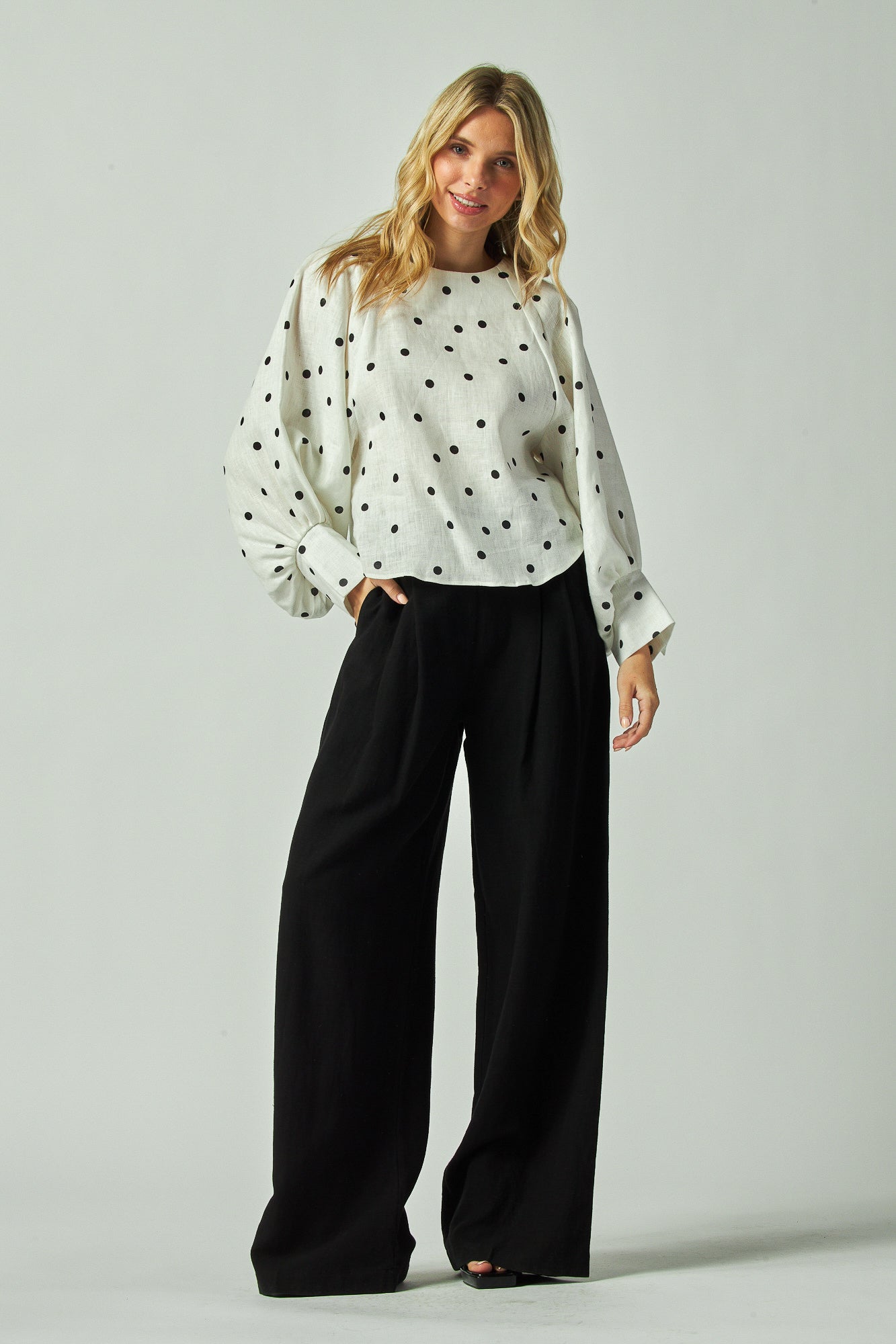 Model wearing a high waist wide-leg slacks 
