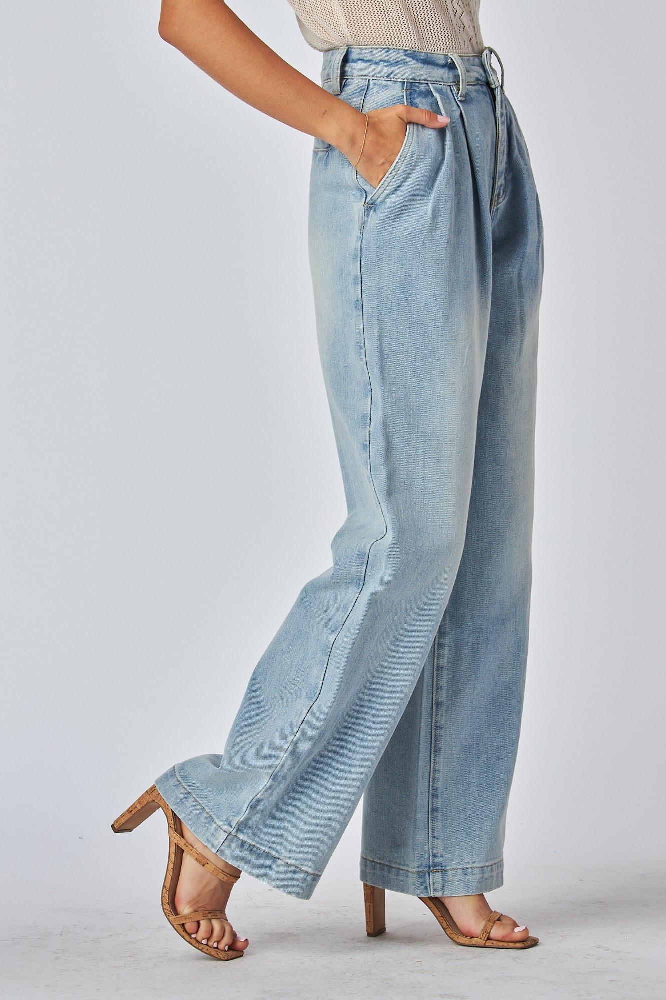 Women showing a flattering high waisted blue jeans
