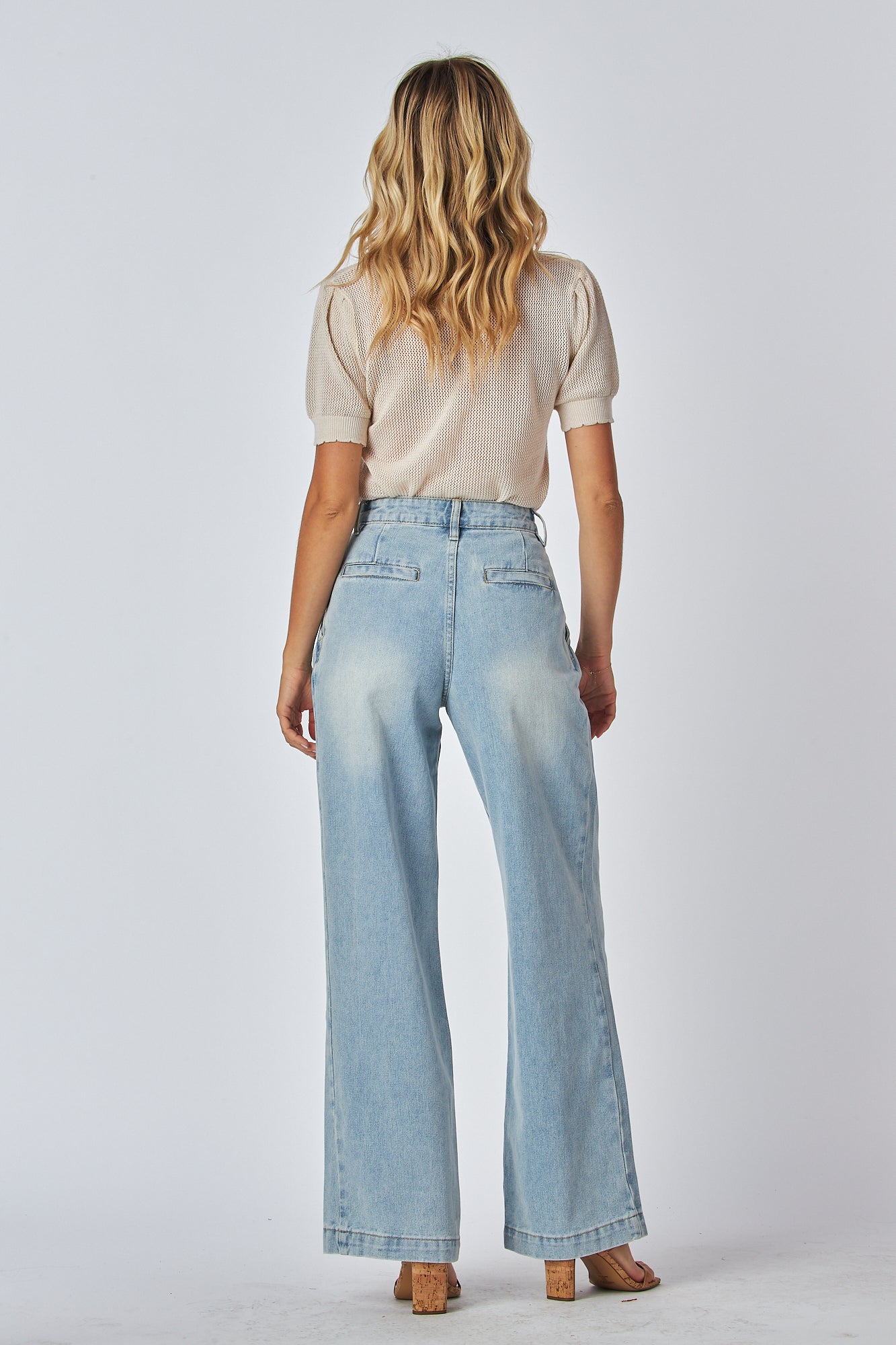 Model Wearing a Zip fly high rise blue jeans
