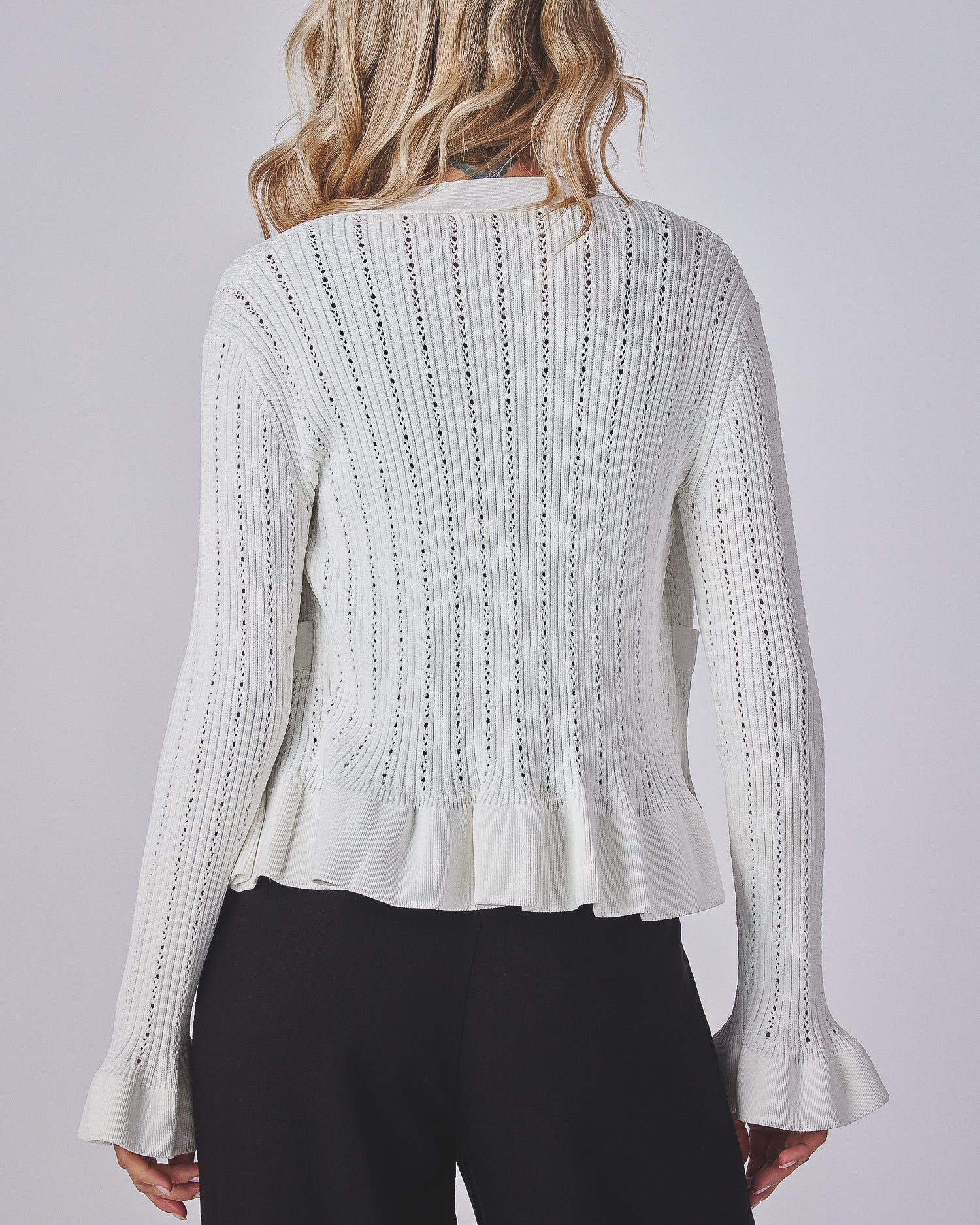 Model wearing a peplum top white