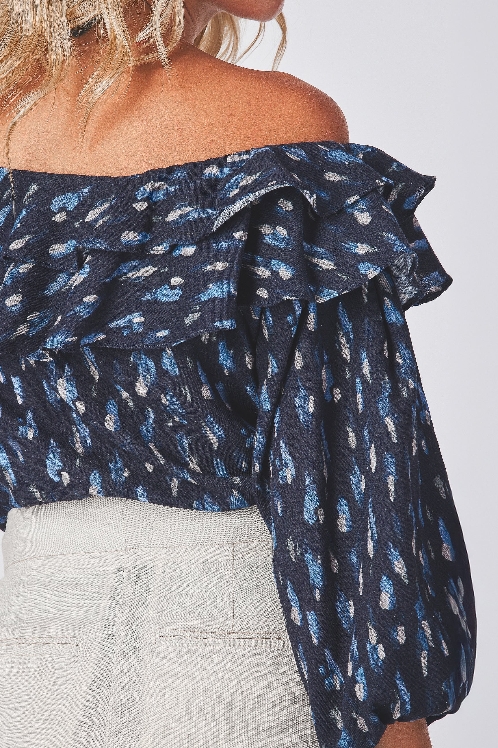 Navy blue sexy off-shoulder top with print pattern on a plain background