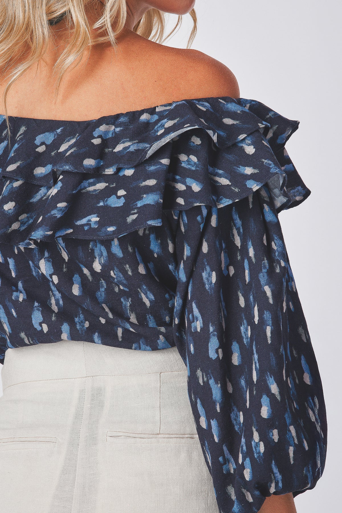 Grazia Top navy top close view of the ruffle neckline over the shoulder