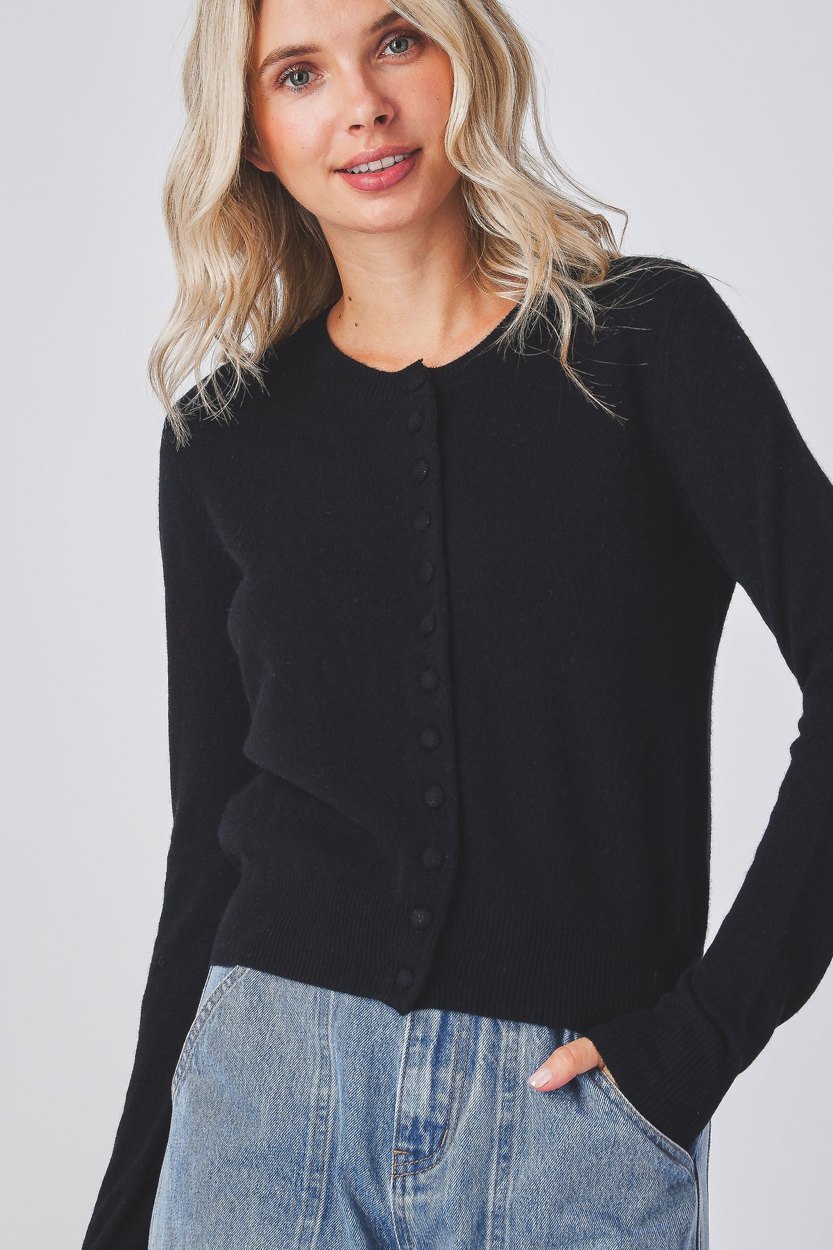 Mabel Cardigan in black knit with a round neckline and covered buttons, front view