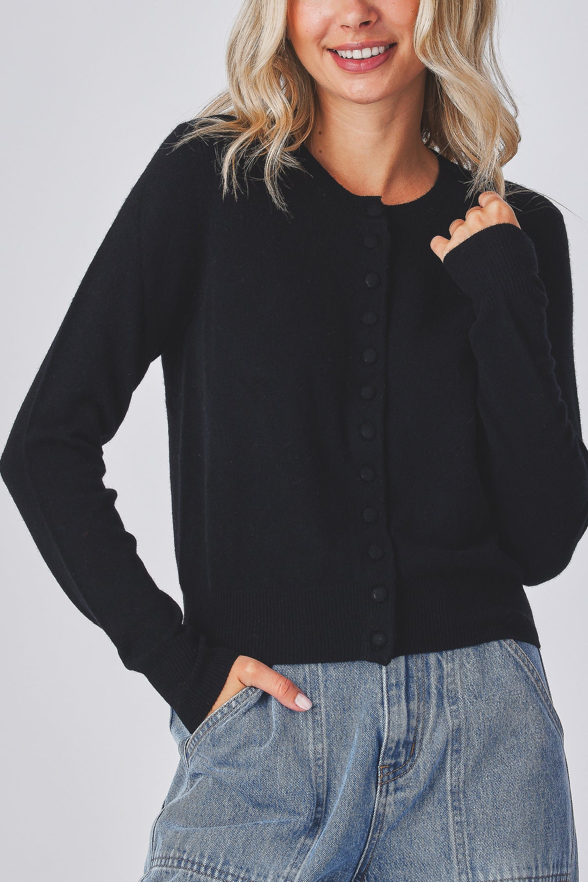 Mabel Cardigan in black, close view of the shoulder and knit texture