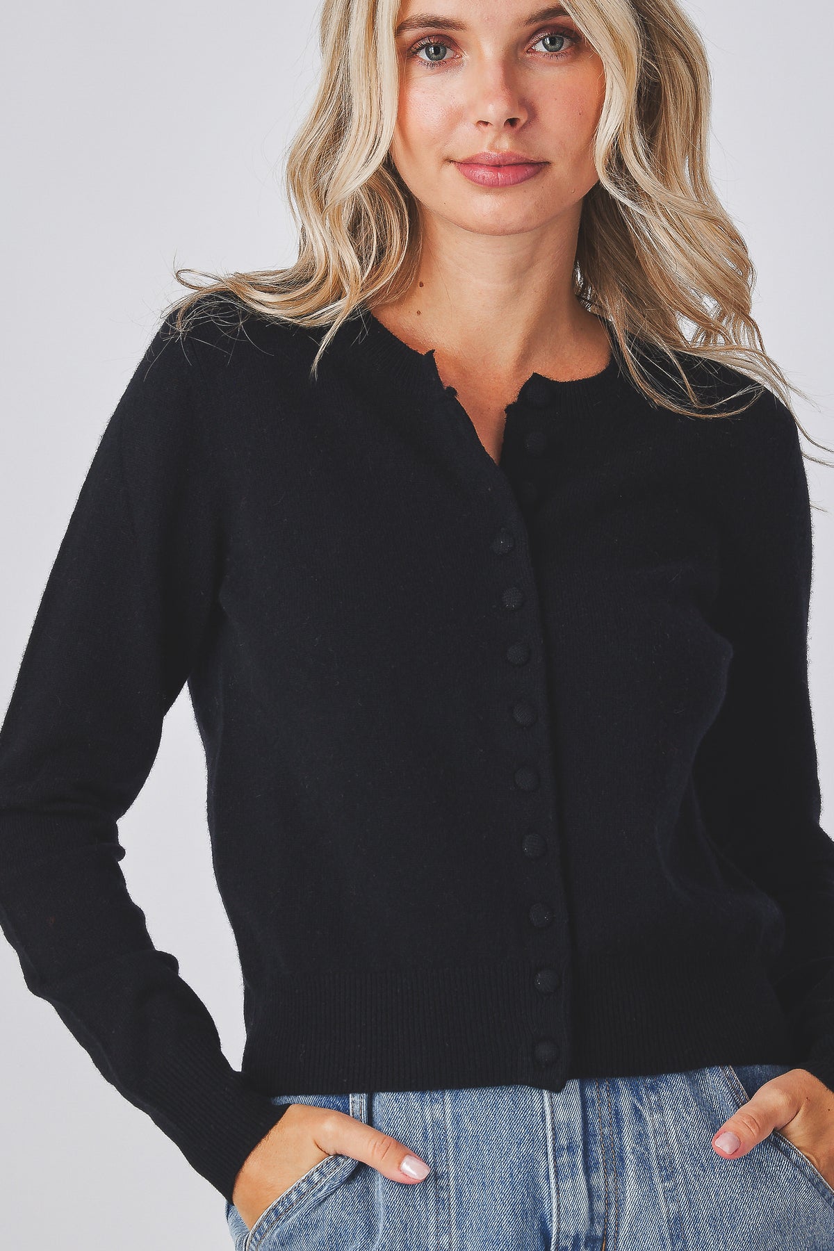 Mabel Cardigan in black showing the covered buttons down the front, detail view