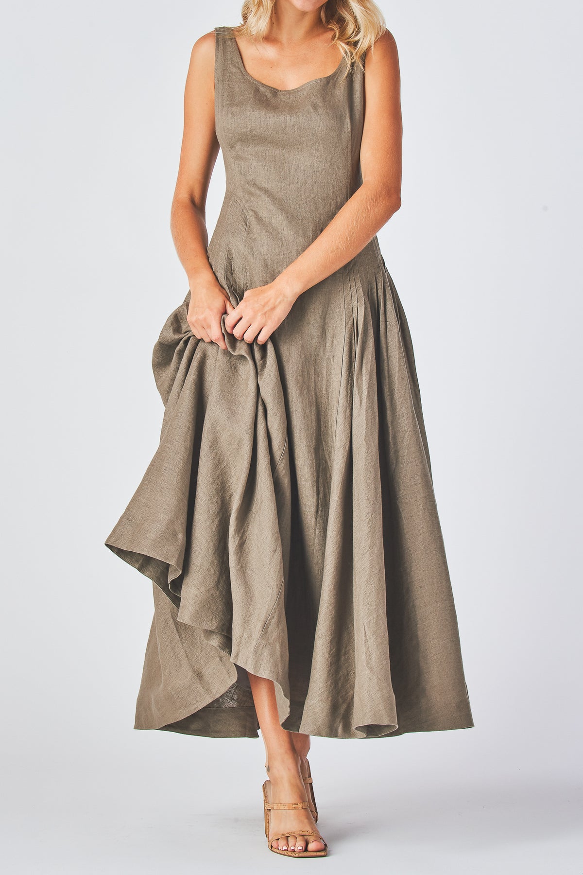 Miranda Dress in mocha linen with the skirt lifted to one side, front view