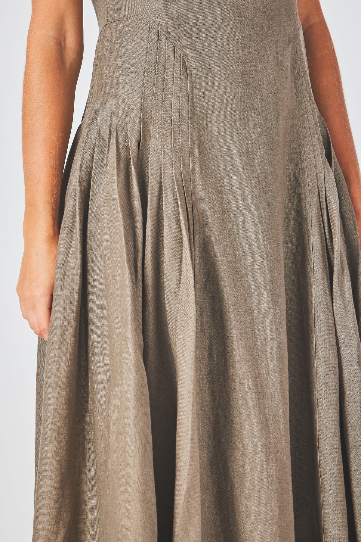 Miranda Dress in mocha linen, detail of the pleats releasing at the hip